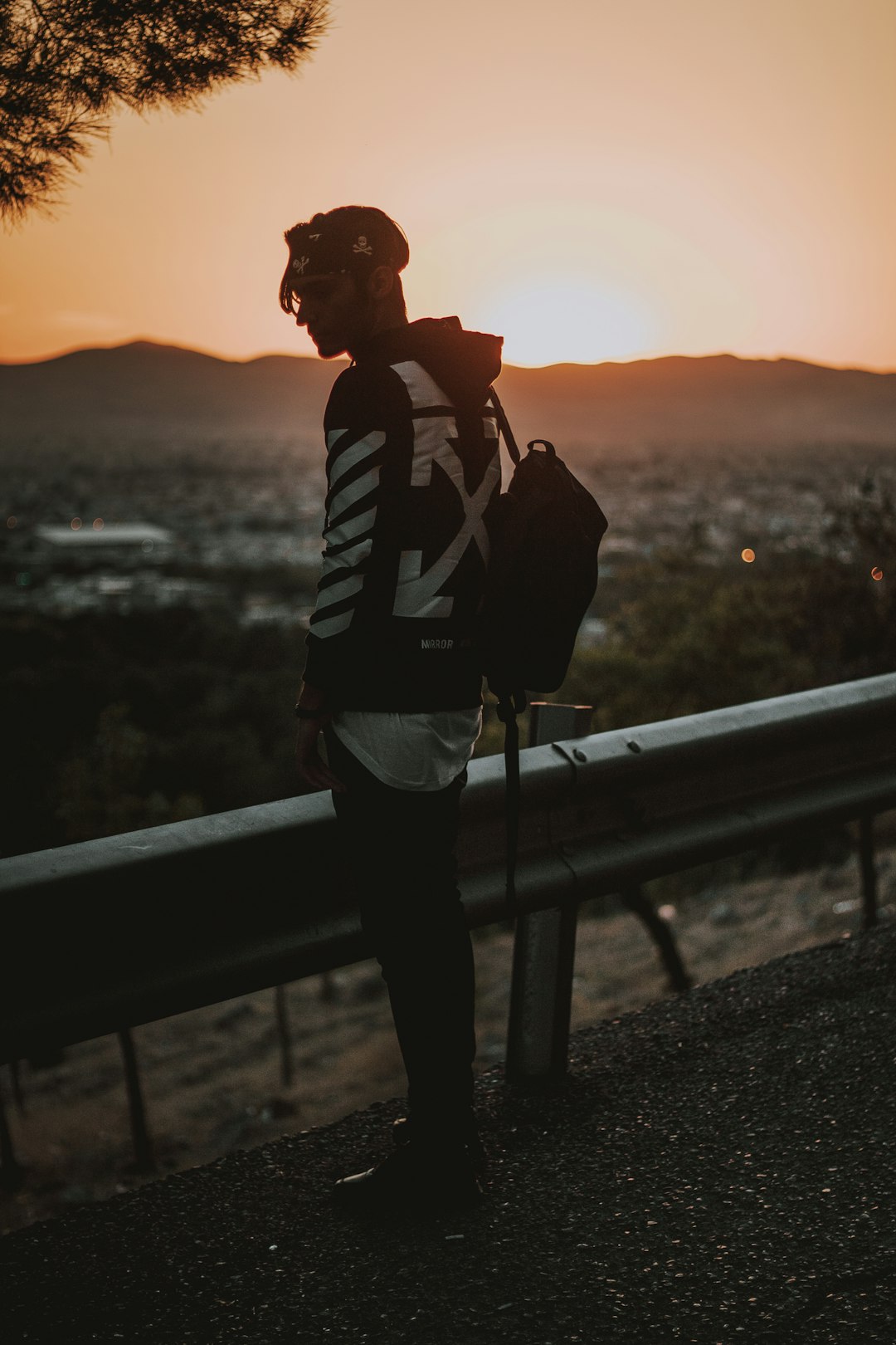 a person standing on a hill at sunset
